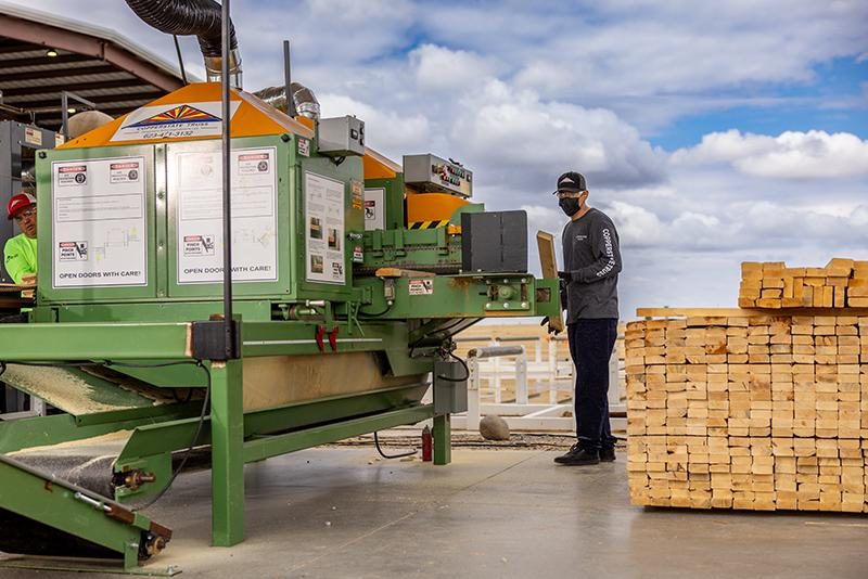 Sawyer loading lumber into the Monet DeSauw web saw at Copperstate Truss in Buckeye, Arizona.